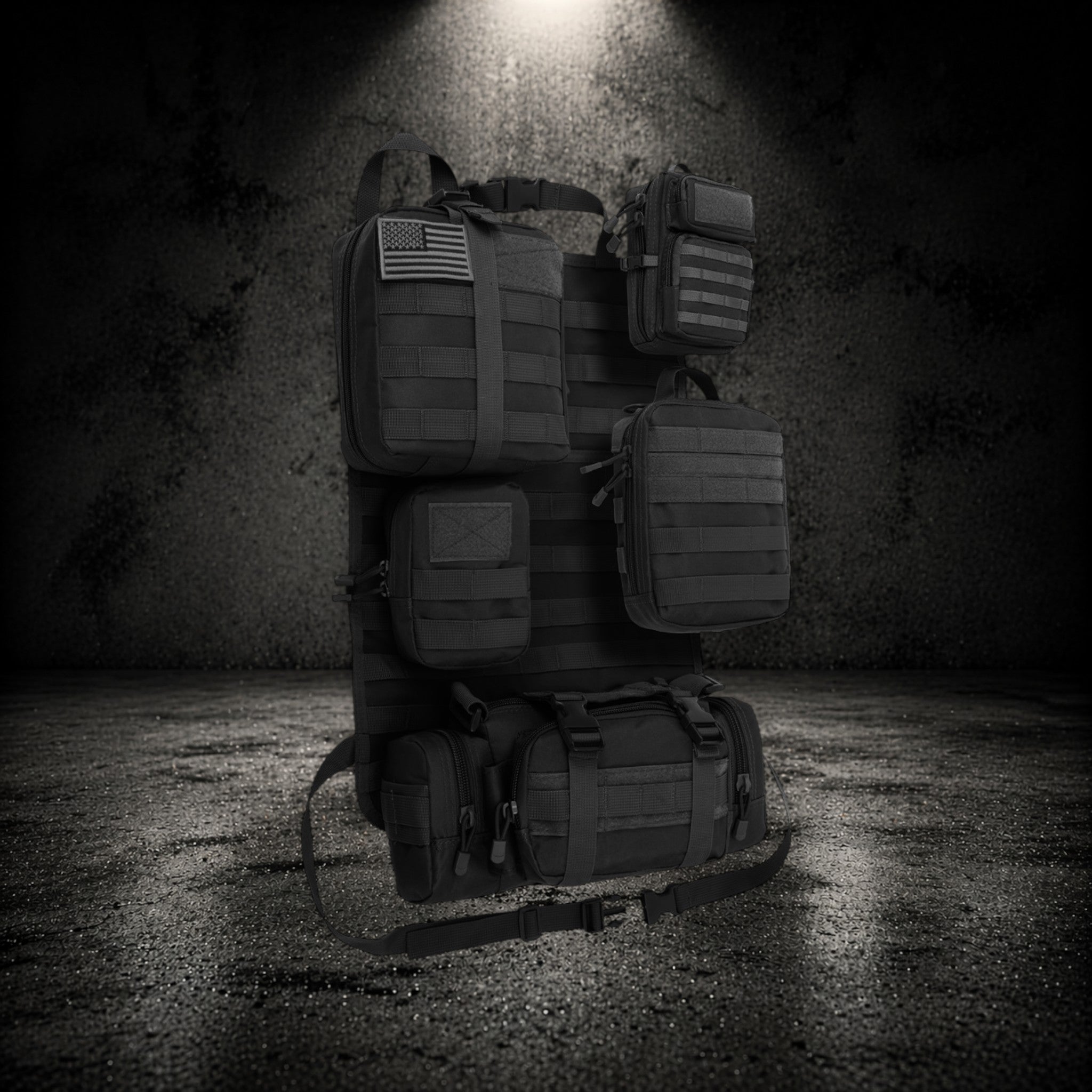 Tactical vehicle organiser with MOLLE system and multiple storage pouches on dark background