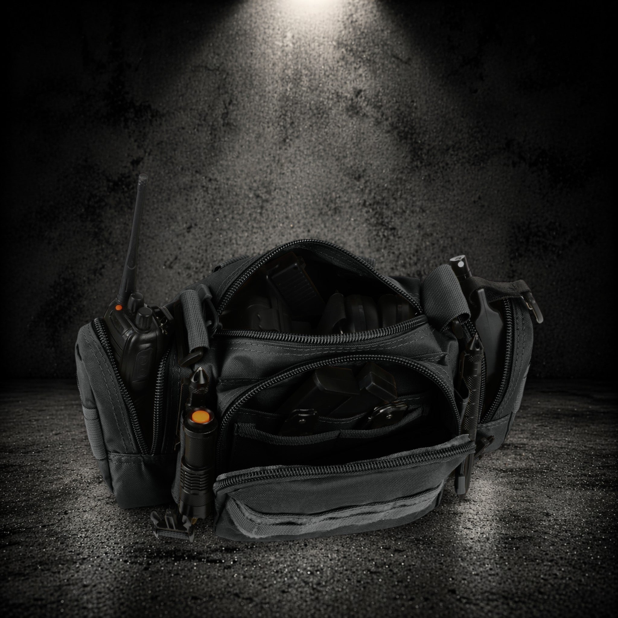 Vehicle organiser large compartment with tactical gear including radio, flashlight, and accessories